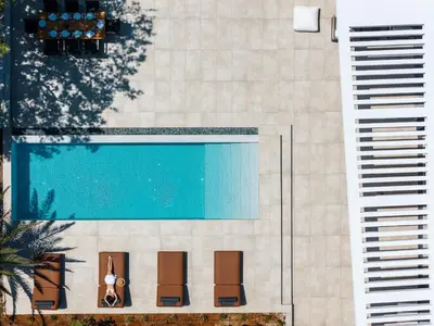 an overhead view of a swimming pool next to two buildings at Nuera Villas in Chania Town