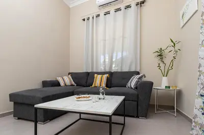 a living room with a couch and a table at GOZA Cozy house in Chania Town