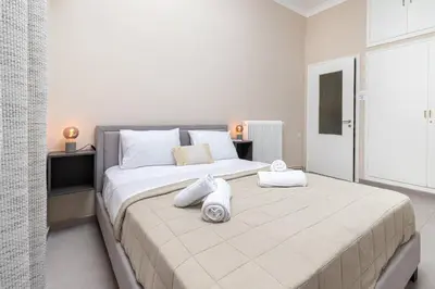 a bedroom with a large bed with towels on it at GOZA Cozy house in Chania Town