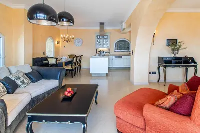 a living room with two couches and a table at Villa Sun Rock - Ravdoucha in Kolymvari