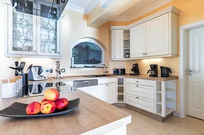 a kitchen with a plate of apples on a counter at Villa Sun Rock - Ravdoucha in Kolymvari