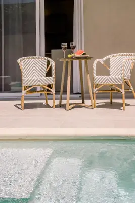 two chairs and a table with wine glasses next to a pool at Nidra Studio with private pool in Chania Town