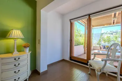a room with a dresser and a chair and a window at Platanias Memories Apartment in Plataniás