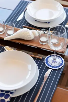 a table with white plates and glasses on a table at Platanias Memories Apartment in Plataniás