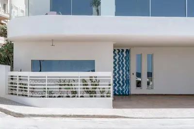 a white house with a blue and white facade at 8 Min walk to Harbour in Chania Town