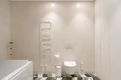 a white bathroom with a toilet and a sink at 8 Min walk to Harbour in Chania Town