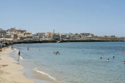 a group of people in the water at the beach at 8 Min walk to Harbour in Chania Town