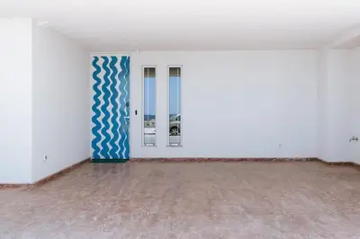 an empty room with a blue and white wall at 8 Min walk to Harbour in Chania Town