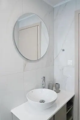 a white bathroom with a sink and a mirror at Niki Luxury Suites Pool Resort 200m From Beach in Chorafakia