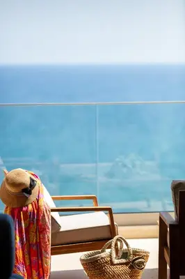a bedroom with a bed and a hat and a basket at Kalyves Coastal Retreat in Chania Town