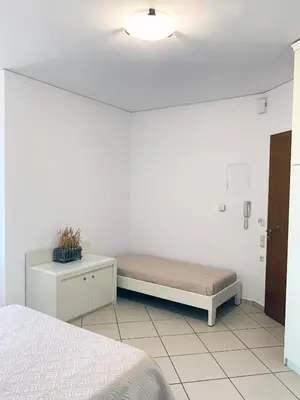 a room with a bed and a bench in a room at Platanias Memories Studio 5 in Plataniás