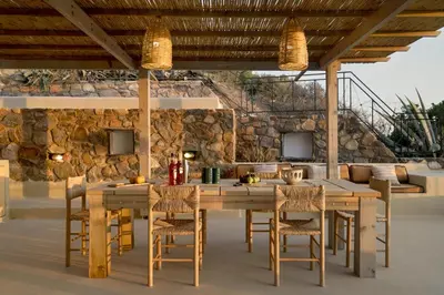 an outdoor dining room with a wooden table and chairs at Newly Renovated villa Artemis with Private Pool just 20min from Elafonissi in Livadia