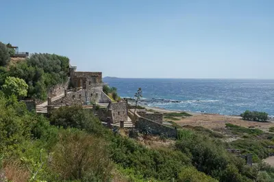 an old building on a hill next to the ocean at Newly Renovated villa Artemis with Private Pool just 20min from Elafonissi in Livadia