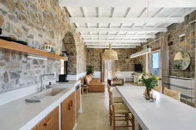 a kitchen with a sink and a living room at Newly Renovated villa Artemis with Private Pool just 20min from Elafonissi in Livadia