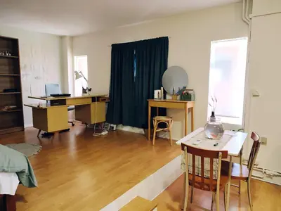 a living room with a desk and a table with a desk at Lovely small apartment in Chania Town