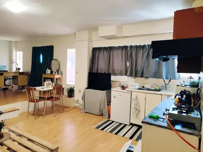 a kitchen and living room with a table and chairs at Lovely small apartment in Chania Town