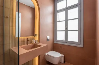 a bathroom with a sink and a toilet and a window at Full House in Chania Town