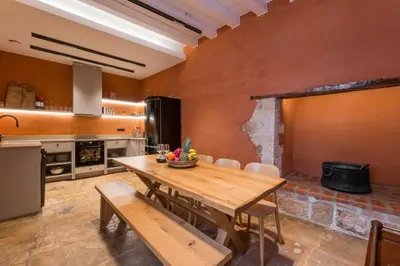 a large kitchen with a wooden table and chairs at Full House in Chania Town