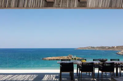 a dining room with a view of the ocean at Beach Rock in Chania Town