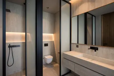 a bathroom with a sink and a toilet and a mirror at Beach Rock in Chania Town