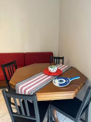 a wooden table with a plate and a bowl on it at Vaso's comfort apartment 1 in Chania Town