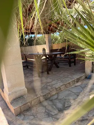a wooden table and bench on a patio at Tzortzinas Cottage in Chania Town