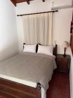 a bedroom with a bed and a window at Tzortzinas Cottage in Chania Town