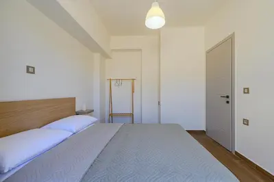 a bedroom with a large bed and a door at Serenity in Stérnai