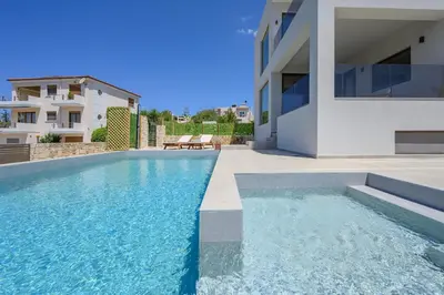 a swimming pool in front of a house at Serenity in Stérnai
