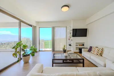 a living room with white furniture and large windows at Serenity in Stérnai