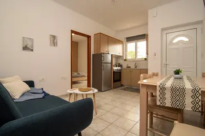 a living room with a couch and a kitchen at Dream Apartments 3 in Palaiochóra