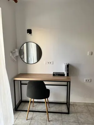 a desk with a mirror and a chair at Dream Apartments 3 in Palaiochóra