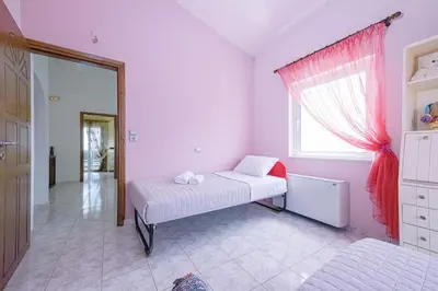 a small bedroom with a bed and a window at Sofia's house 2 in Chania Town