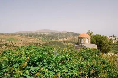a small tower on top of a hill with trees at Sofia's house 2 in Chania Town