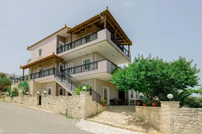 a large house with a stone retaining wall at Sofia's house 2 in Chania Town