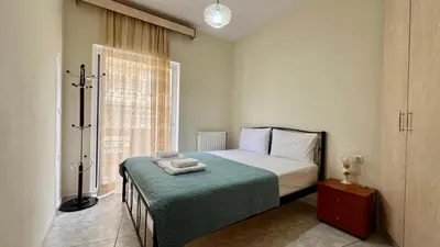 a small bedroom with a bed and a window at Angie A2 close to the beach by 8essentially in Chania Town