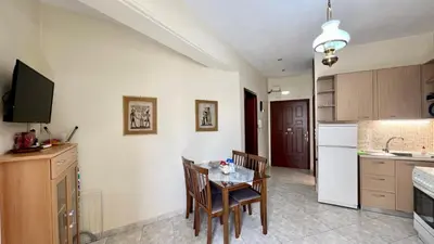 a kitchen with a table and chairs in a room at Angie A2 close to the beach by 8essentially in Chania Town