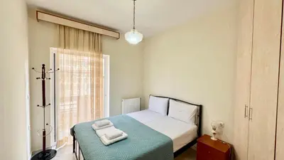 a small bedroom with a bed and a window at Angie A2 close to the beach by 8essentially in Chania Town