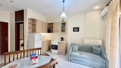 a living room with a couch and a table at Angie A2 close to the beach by 8essentially in Chania Town