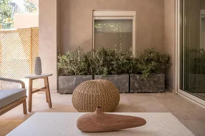 a living room with a large pot of plants at Hestia Boutique Rooms in Agia Marina Nea Kydonias