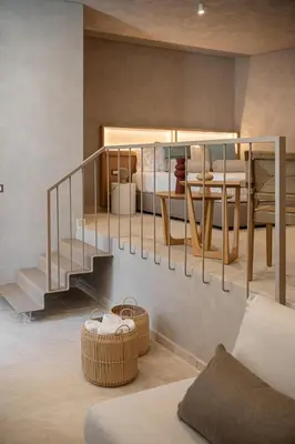 a room with a bed and a staircase with a bed at Hestia Boutique Rooms in Agia Marina Nea Kydonias