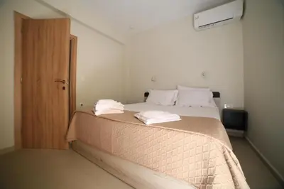 a bedroom with a bed with two towels on it at GREEN n' BLUE apartments in Kalamaki Chanion