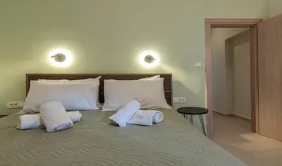 a bedroom with a bed with two pillows on it at GREEN n' BLUE apartments in Kalamaki Chanion