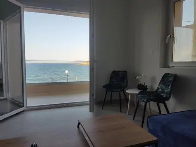 a living room with a view of the ocean at GREEN n' BLUE apartments in Kalamaki Chanion