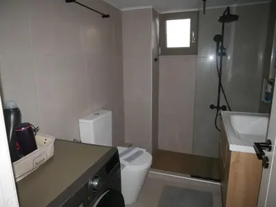 a small bathroom with a toilet and a sink at Gio's Central Cosy Apartment with private balcony in Chania Town