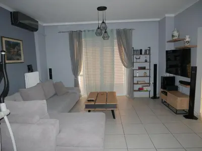 a living room with a white couch and a coffee table at Gio's Central Cosy Apartment with private balcony in Chania Town