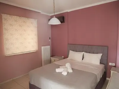 a bedroom with a bed with two towels on it at Gio's Central Cosy Apartment with private balcony in Chania Town