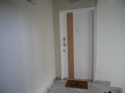 a room with a door with a sign that says home at Gio's Central Cosy Apartment with private balcony in Chania Town
