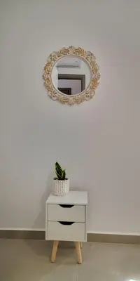 a white dresser with a mirror on a wall at Iris&Phaedra in Ayiá