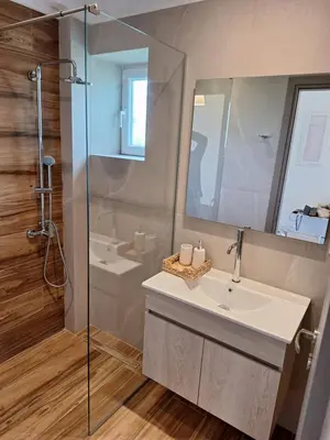 a bathroom with a sink and a glass shower at Iris&Phaedra in Ayiá